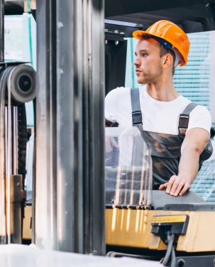 Young man working at a warehouse with boxes