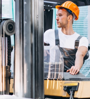 Young man working at a warehouse with boxes