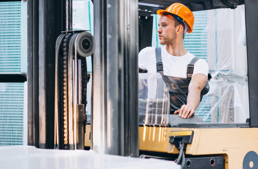 Young man working at a warehouse with boxes